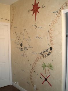 a wall with some drawings on it and a door in the corner next to it