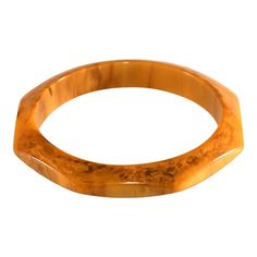 This is part of Chairish’s Costume Jewelry assortment.  Bakelite octagon shaped bangle bracelet with marbling ranging from butterscotch to lighter yellow to brown. We believe this piece dates to the 1930s. Unmarked. Measures about 7.75 inches in circumference inside and a little under 1/2" wide. Looks fantastic layered with other bangles. Vintage Amber Bangle Bracelet, Brown Rectangular Vintage Bracelet, Bakelite Jewelry, Vintage Bakelite, Light Yellow, Yellow And Brown, Costume Jewelry, Bangle Bracelets, Bangles