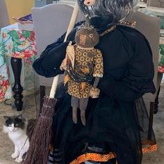 a stuffed animal sitting on top of a chair next to a black and white cat