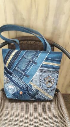 a handbag made out of jeans sitting on top of a wicker chair next to a wall