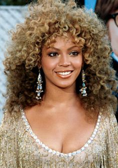 a close up of a person with curly hair