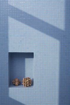 two wooden cubes in a blue wall