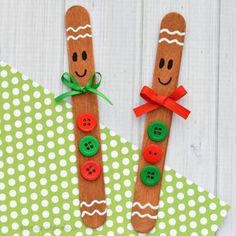 two wooden sticks with buttons on them are decorated to look like gingers