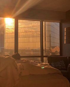 the sun is shining through some windows in a bedroom