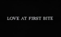 the words love at first bite written in white on a black background