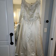 a white dress hanging on a door way