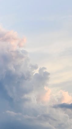 an airplane is flying high in the sky with clouds behind it and one plane has just taken off