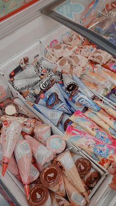 an open refrigerator filled with lots of different types of candy and candies on display