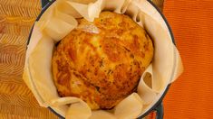 a baked item in a pot on an orange towel