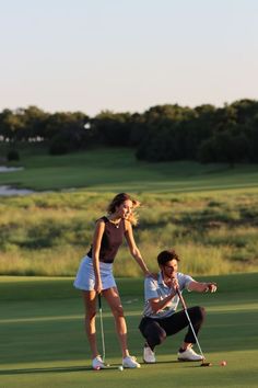 a woman is playing golf with a man