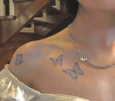 a woman with butterfly tattoos on her chest