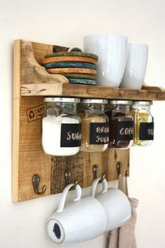 a wooden shelf with coffee cups and mugs on it, hanging from the wall