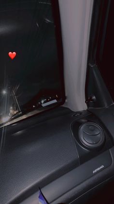 the interior of a car with a red heart on it