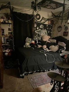 a bed room with a neatly made bed and several stuffed animals on the bed top