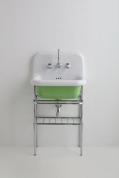 a white sink sitting on top of a metal shelf