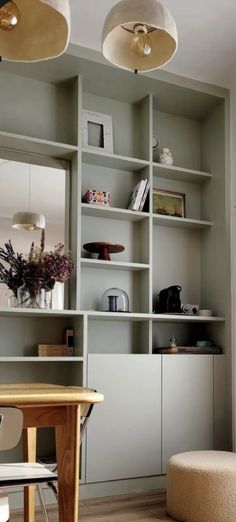 a living room filled with furniture and lots of shelves