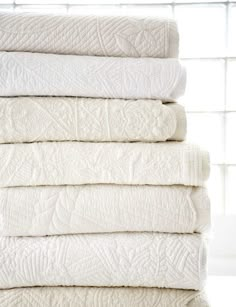 a stack of white towels sitting on top of each other