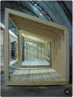 the inside of a building with wooden flooring and walls that have been built into it