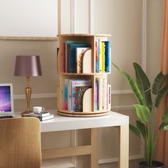 a desk with a laptop, bookshelf and lamp on it in front of a window