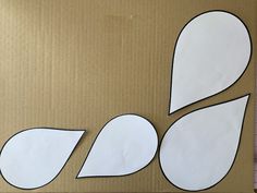 a cardboard box with cut out paper shapes on it, including an oval and leaf shape