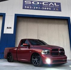 a red truck parked in front of a building