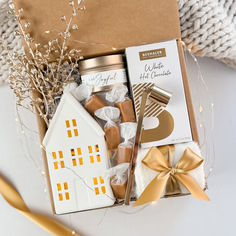 a gift box filled with chocolates, marshmallows and other holiday treats