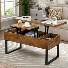 a coffee table with an open drawer underneath it in front of a couch and window