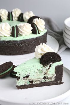 two pieces of cake with oreo cookies and mint green frosting on the top