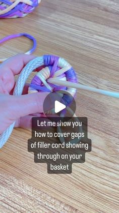 someone is holding a ball of yarn on a wooden table with the words let me show you how to cover gaps of filler cord showing through on your basket