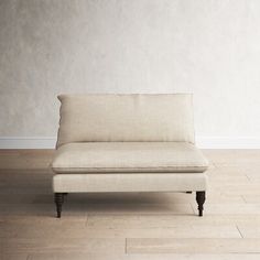 a white couch sitting on top of a hard wood floor