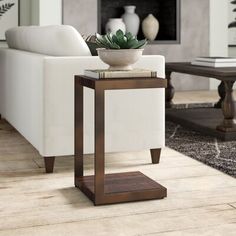 a living room with a white couch and coffee table