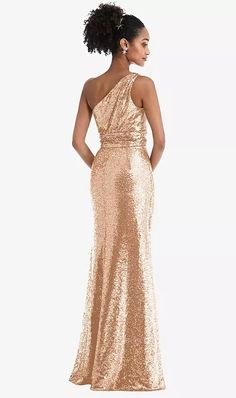 a woman in a gold dress looking back