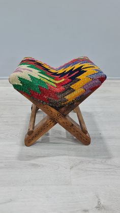 a multicolored bench with wooden legs