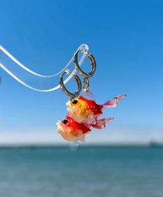 a goldfish hanging from a hook in the air