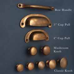 several brass handles and knobs on a blue surface