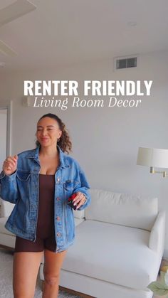 a woman standing in front of a couch with the words renter friendly living room decor