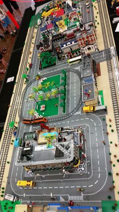 a model train track with cars and trucks on it