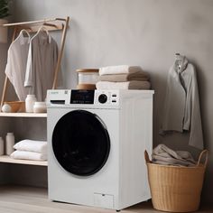 a white washer sitting next to a dryer on top of a wooden floor