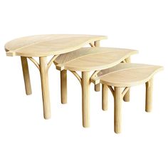 three wooden tables sitting next to each other