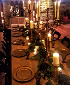 a long table with candles and plates on it