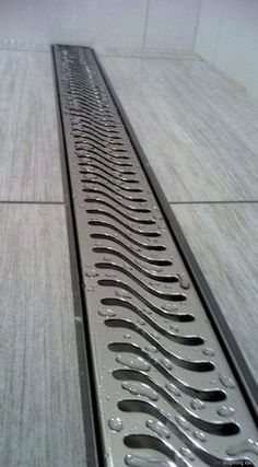 a metal grate sitting on top of a tiled floor