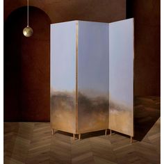 a room divider with an abstract painting on the front and back panels in gold