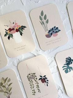 six coasters with flowers and plants on them against a white brick wall, all in different colors