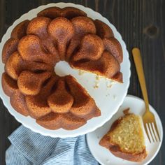 a bundt cake on a plate next to a slice of cake and a fork