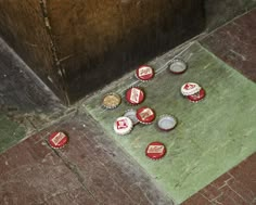 several red and white soda bottle caps on the ground