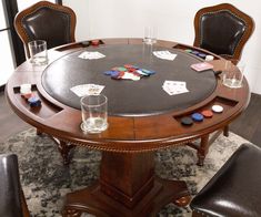 a round table with chairs around it and playing cards on the table in front of them