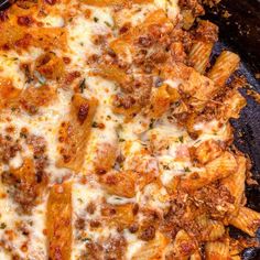 a pan filled with pasta and meat covered in cheese