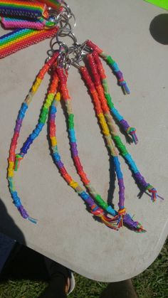 a bunch of beads that are on top of a surfboard with a chain attached to it