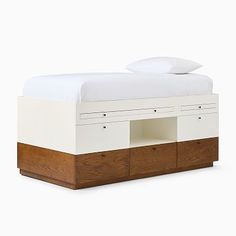 a bed with two drawers underneath it and a white blanket on top of the bed