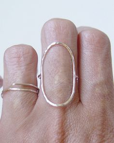 This stunning ring features a oval open circle band of 14K gold fill that wraps around your finger reminiscent of planet Saturn. Stylish and elegant. Perfect for everyday wear. Please specify your ring size and material at the checkout convo section. These rings are made to order. My QUALITY: Gold filled pieces contain 100+ times more real gold than gold plated pieces. They are durable and tarnish resistant. Gold filled pieces are a high quality, affordable alternative to solid gold for people w Everyday Stackable Oval Rings With Polished Finish, Everyday Oval Stackable Rings With Polished Finish, Modern Oval Stackable Rings With Polished Finish, Modern Oval Hand Forged Jewelry, Hand Forged Oval Ring, Sterling Silver Oval Stackable Rings, Simple Oval Sterling Silver Rings, Modern Oval Rings With Simple Design, Modern Oval Jewelry With Simple Design